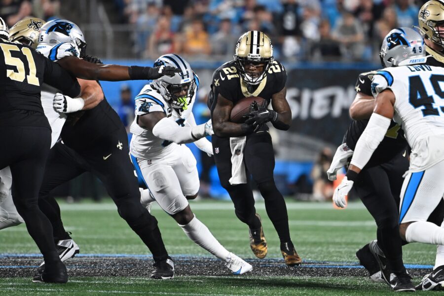 Sep 18, 2023; Charlotte, North Carolina, USA; New Orleans Saints running back Jamaal Williams (21) with the ball as Carolina Panthers linebacker Brian Burns (0) and linebacker Frankie Luvu (49) defend in the first quarter at Bank of America Stadium. Mandatory Credit: Bob Donnan-USA TODAY Sports