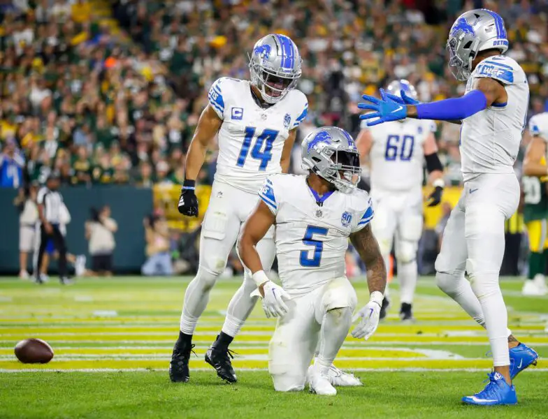 Detroit Lions running back David Montgomery (5) celebrates with wide receiver Amon-Ra St. Brown (14) and wide receiver Josh Reynolds (8) after scoring a touchdown against the Green Bay Packers during their football game on Thursday, September 28, 2023, at Lambeau Field in Green Bay, Wis.