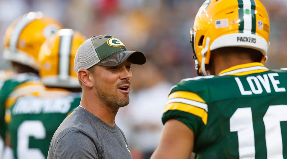 Aug 14, 2021; Green Bay, Wisconsin, USA; Green Bay Packers head coach Matt LaFleur talks with quarterback Jordan Love (10) during warmups prior to a game against the Houston Texans at Lambeau Field. Mandatory Credit: Jeff Hanisch-USA TODAY Sports