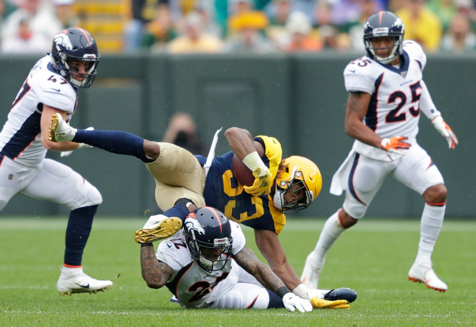 Green Bay Packers running back Aaron Jones (33) is upended by Denver Broncos defensive back Kareem Jackson (22) in the first half Sunday, September 22, 2019, at Lambeau Field in Green Bay, Wis. Dan Powers/USA TODAY NETWORK-Wisconsin Apc Packvsbroncos 0922190174