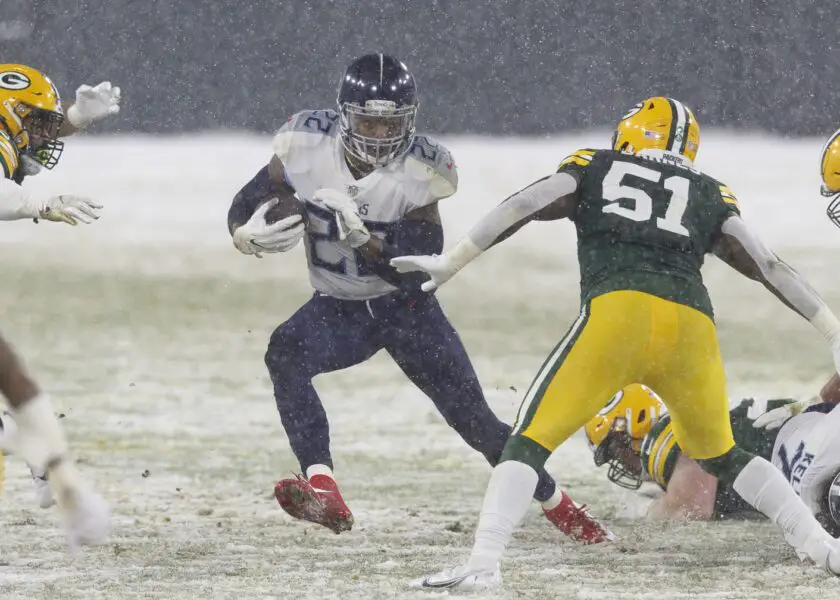Dec 27, 2020; Green Bay, Wisconsin, USA; Tennessee Titans running back Derrick Henry (22) rushes with the football during the second quarter against the Green Bay Packers at Lambeau Field. Mandatory Credit: Jeff Hanisch-USA TODAY Sports