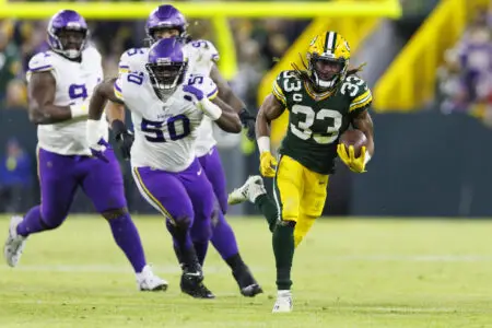Jan 1, 2023; Green Bay, Wisconsin, USA; Green Bay Packers running back Aaron Jones (33) rushes with the football during the second quarter against the Minnesota Vikings at Lambeau Field. Mandatory Credit: Jeff Hanisch-USA TODAY Sports