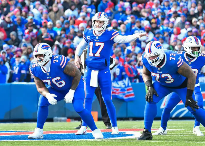 Jan 15, 2023; Orchard Park, New York, USA; Buffalo Bills quarterback Josh Allen (17) at the line of scrimmage with guard Rodger Saffold (76) and offensive tackle Dion Dawkins (73) in the first quarter of a wild card game against the Miami Dolphins at Highmark Stadium. Mandatory Credit: Mark Konezny-USA TODAY Sports (Aaron Rodgers - New York Jets)