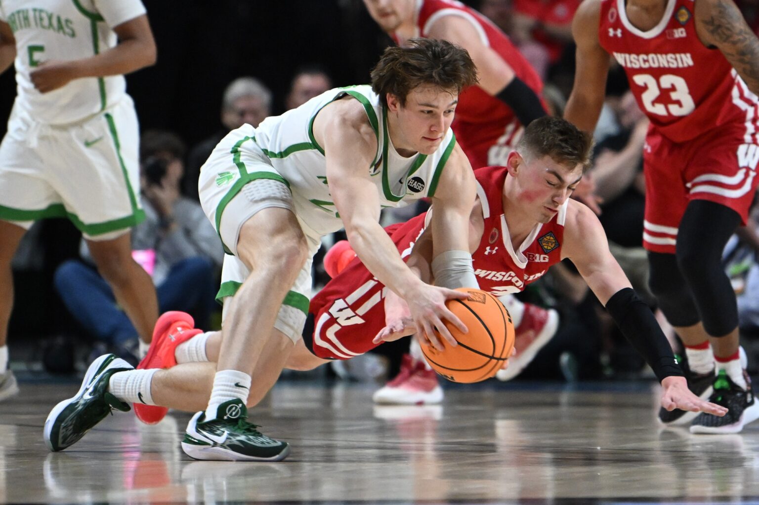 Wisconsin Badgers guard Connor Essegian dives for a loose ball.