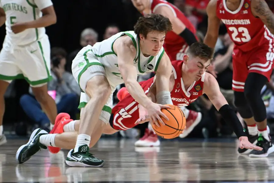 Wisconsin Badgers basketball guard Connor Essegian dives for a loose ball.