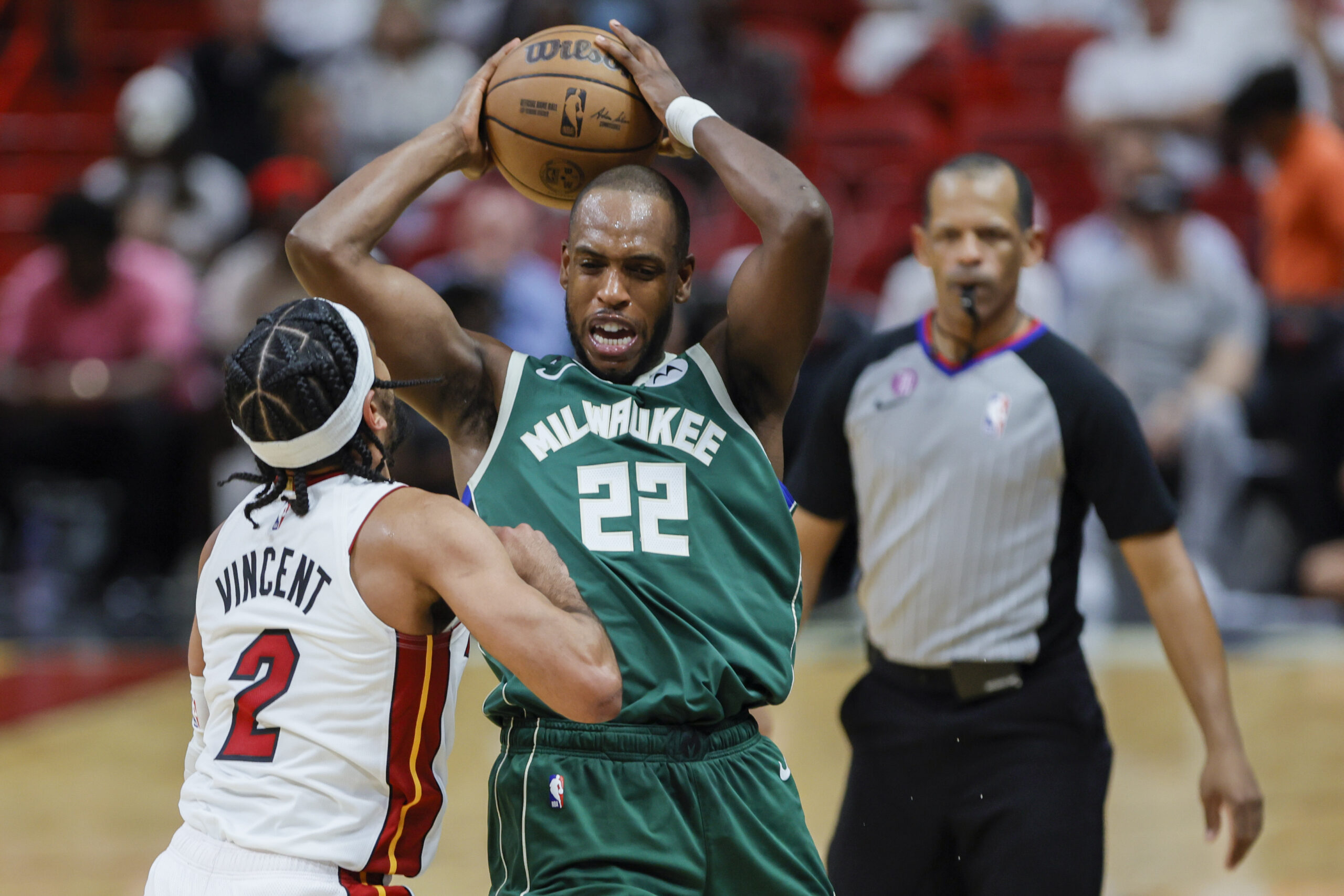 Apr 22, 2023; Miami, Florida, USA; Milwaukee Bucks forward Khris Middleton (22) protects the basketball from Miami Heat guard Gabe Vincent (2) in the third quarter during game three of the 2023 NBA Playoffs at Kaseya Center. Mandatory Credit: Sam Navarro-USA TODAY Sports