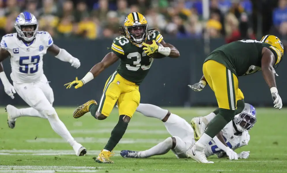 Sep 28, 2023; Green Bay, Wisconsin, USA; Green Bay Packers running back Aaron Jones (33) runs the ball against the Detroit Lions during their football game on Thursday, September 28, 2023, at Lambeau Field in Green Bay, Wis. The Lions won the game, 34-20. Mandatory Credit: Tork Mason-USA TODAY Sports