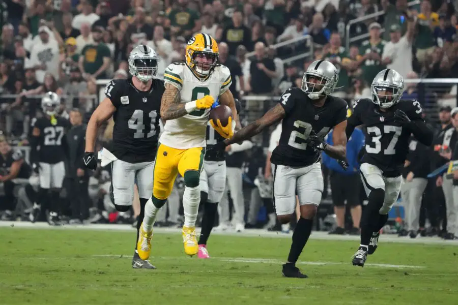 Oct 9, 2023; Paradise, Nevada, USA; Green Bay Packers wide receiver Christian Watson (9) is pursued by Las Vegas Raiders linebacker Robert Spillane (41), cornerback Marcus Peters (24) and cornerback Tyler Hall (37) on a 77-yard reception in the second half at Allegiant Stadium. Mandatory Credit: Kirby Lee-USA TODAY Sports