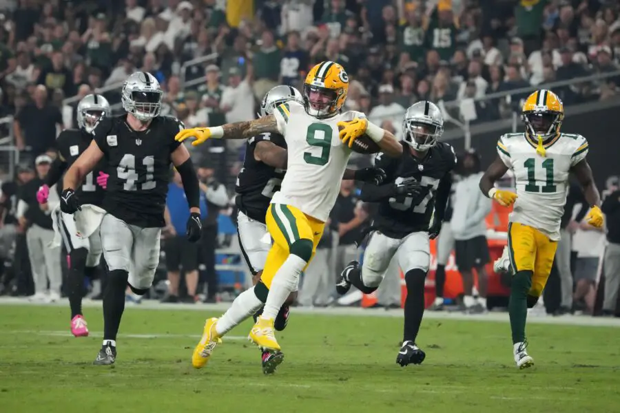 Oct 9, 2023; Paradise, Nevada, USA; Green Bay Packers wide receiver Christian Watson (9) is pursued by Las Vegas Raiders linebacker Robert Spillane (41), cornerback Marcus Peters (24) and cornerback Tyler Hall (37) on a 77-yard reception in the second half at Allegiant Stadium. Mandatory Credit: Kirby Lee-USA TODAY Sports