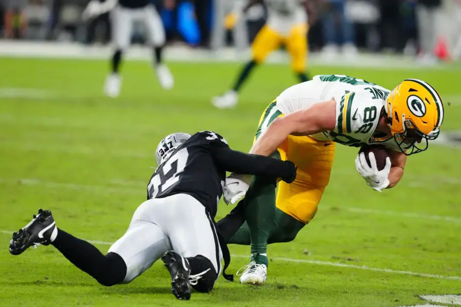 Oct 9, 2023; Paradise, Nevada, USA; Las Vegas Raiders cornerback Tyler Hall (37) tackles Green Bay Packers tight end Luke Musgrave (88) during the second quarter at Allegiant Stadium. Mandatory Credit: Stephen R. Sylvanie-USA TODAY Sports