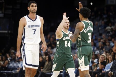 Oct 10, 2023; Memphis, Tennessee, USA; Milwaukee Bucks guard Pat Connaughton (24) reacts with forward MarJon Beauchamp (3) after a three point basket during the first half against the Memphis Grizzlies at FedExForum. Mandatory Credit: Petre Thomas-USA TODAY Sports