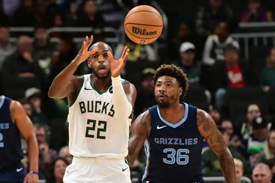 Oct 20, 2023; Milwaukee, Wisconsin, USA; Milwaukee Bucks center Khris Middleton (22) catches a pass in front of Memphis Grizzlies guard Marcus Smart (36) in the first quarter at Fiserv Forum. Mandatory Credit: Benny Sieu-USA TODAY Sports