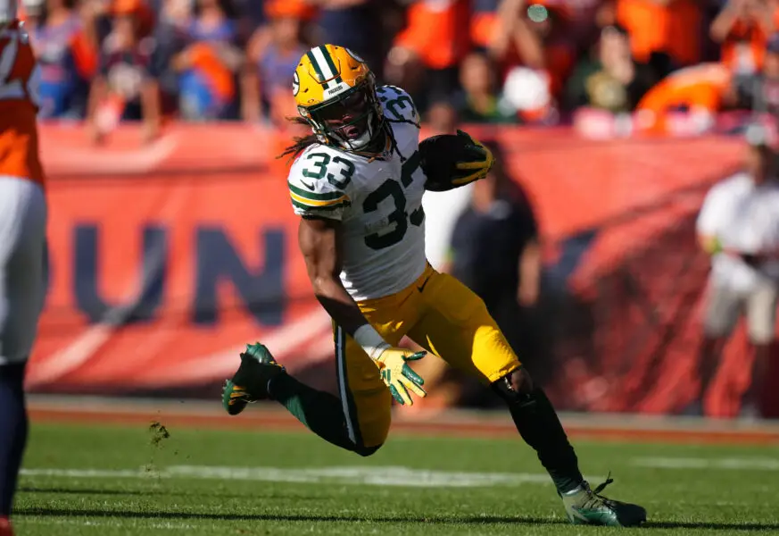 Oct 22, 2023; Denver, Colorado, USA; Green Bay Packers running back Aaron Jones (33) carries the ball in the second quarter against the Denver Broncos at Empower Field at Mile High. Mandatory Credit: Ron Chenoy-USA TODAY Sports