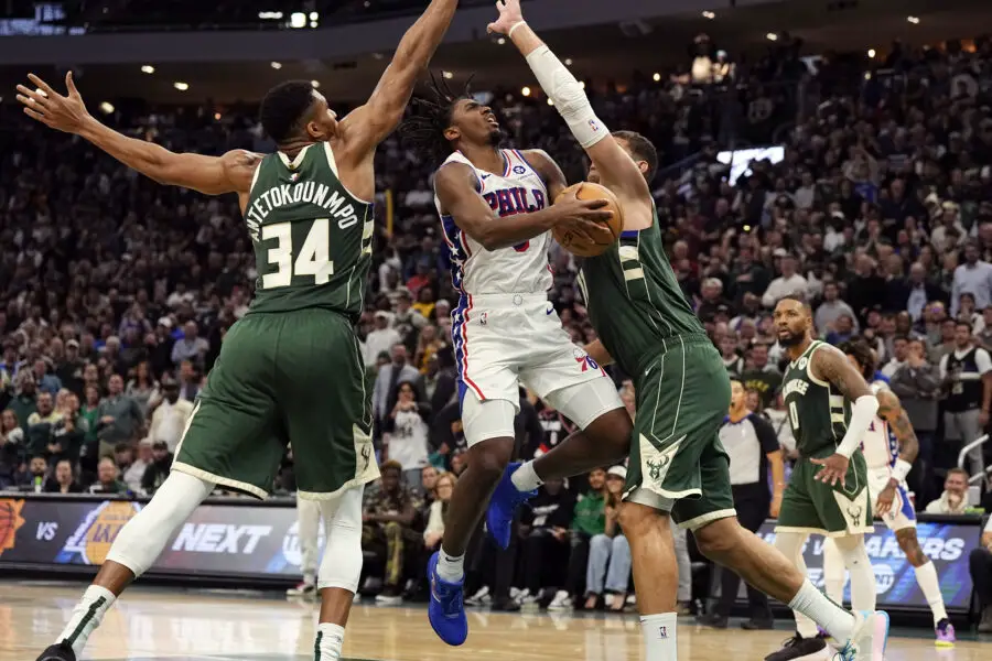 Oct 26, 2023; Milwaukee, Wisconsin, USA; Philadelphia 76ers guard Tyrese Maxey (0) drives for the basket between Milwaukee Bucks forward Giannis Antetokounmpo (34) ad center Brook Lopez (11) during the fourth quarter at Fiserv Forum. Mandatory Credit: Jeff Hanisch-USA TODAY Sports