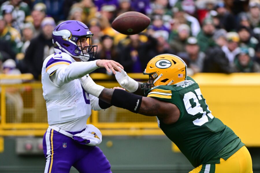 Oct 29, 2023; Green Bay, Wisconsin, USA; Minnesota Vikings quarterback Kirk Cousins (8) gets a pass away while under pressure from Green Bay Packers linebacker Kenny Clark (97) in the first quarter at Lambeau Field. Mandatory Credit: Benny Sieu-USA TODAY Sports