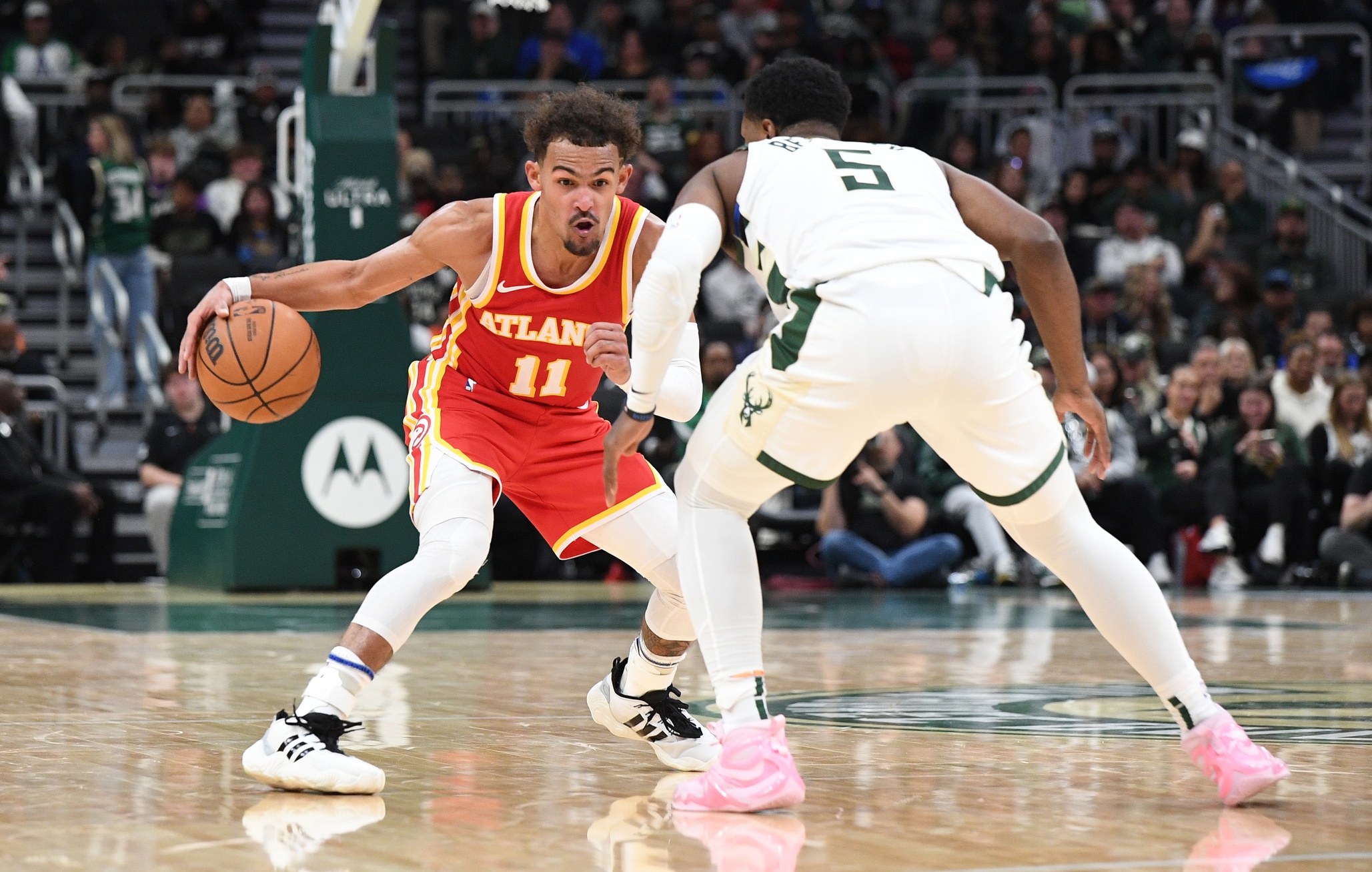 Oct 29, 2023; Milwaukee, Wisconsin, USA; Atlanta Hawks guard Trae Young (11) brings the ball up the court against Milwaukee Bucks guard Malik Beasley (5) in the second half at Fiserv Forum. Mandatory Credit: Michael McLoone-USA TODAY Sports