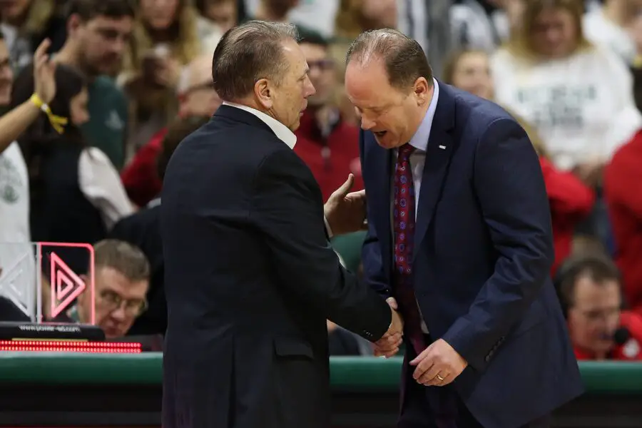 Wisconsin basketball coach Greg Gard meets with Spartans coach Tom Izzo