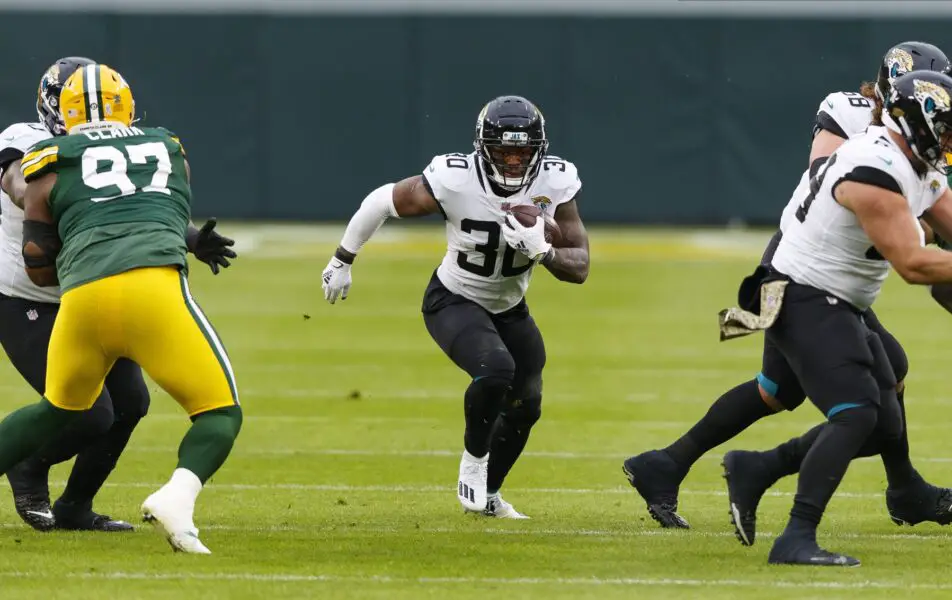Nov 15, 2020; Green Bay, Wisconsin, USA; Jacksonville Jaguars running back James Robinson (30) runs the football against the Green Bay Packers during the first quarter at Lambeau Field. Mandatory Credit: Jeff Hanisch-USA TODAY Sports