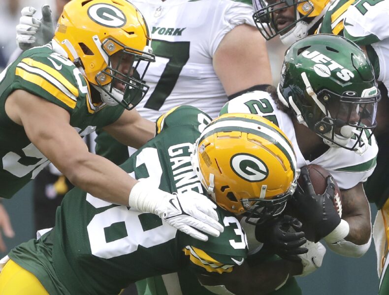 Aug 21, 2021; Green Bay, Wisconsin, USA; Green Bay Packers safety Innis Gaines (38) and linebacker Tipa Galeai tackle New York Jets running back Ty Johnson (25) during a preseason game at Lambeau Field Mandatory Credit: William Glasheen/Appleton Post-Crescent via USA TODAY NETWORK