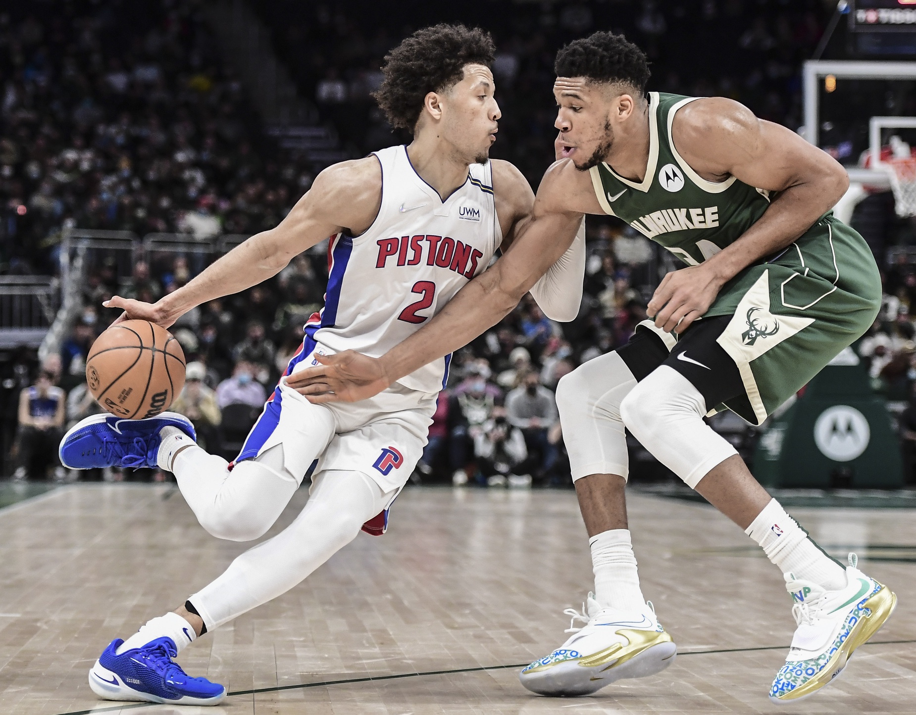 Jan 3, 2022; Milwaukee, Wisconsin, USA; Milwaukee Bucks forward Giannis Antetokounmpo (34) steals the ball from Detroit Pistons guard Cade Cunningham (2) in the fourth quarter at Fiserv Forum. Mandatory Credit: Benny Sieu-USA TODAY Sports