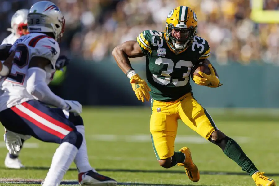 Oct 2, 2022; Green Bay, Wisconsin, USA; Green Bay Packers running back Aaron Jones (33) rushes with the football during the second quarter against the New England Patriots at Lambeau Field. Mandatory Credit: Jeff Hanisch-USA TODAY Sports