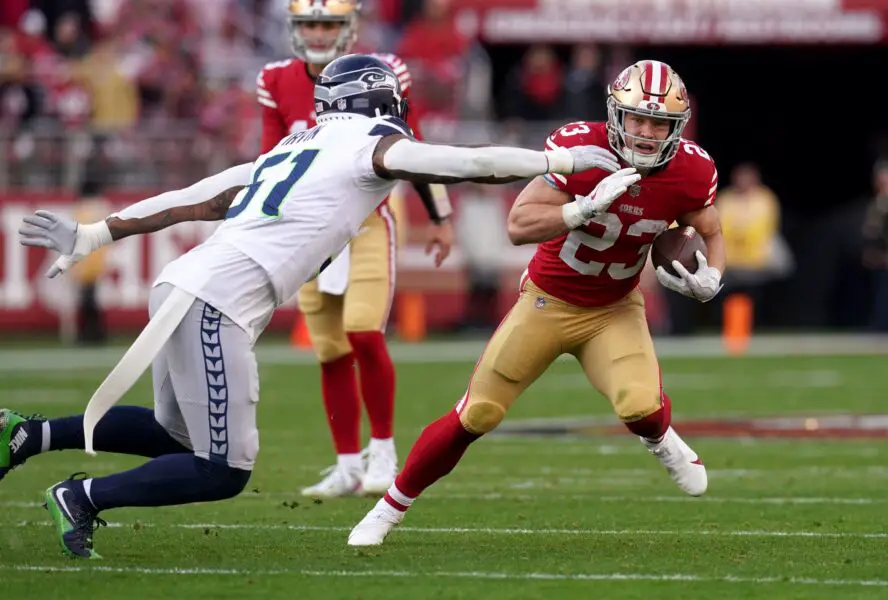 Jan 14, 2023; Santa Clara, California, USA; San Francisco 49ers running back Christian McCaffrey (23) is defended by Seattle Seahawks linebacker Bruce Irvin (51) in the second quarter during a wild card game at Levi's Stadium. Mandatory Credit: Cary Edmondson-USA TODAY Sports (Green Bay Packers - Detroit Lions)