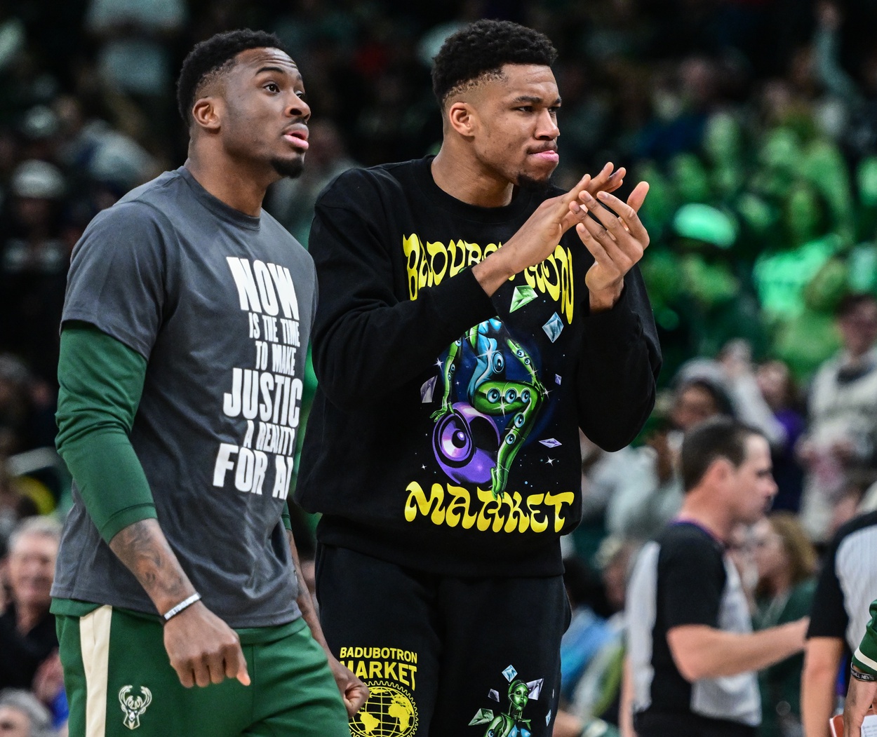 Jan 16, 2023; Milwaukee, Wisconsin, USA; Milwaukee Bucks forward Giannis Antetokounmpo (right) cheers from the bench in the fourth quarter during game against the Indiana Pacers at Fiserv Forum. Antetokounmpo did not play due to an injury. Mandatory Credit: Benny Sieu-USA TODAY Sports