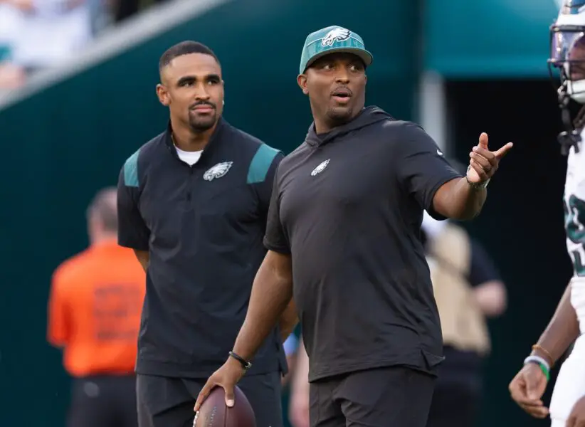 Aug 17, 2023; Philadelphia, Pennsylvania, USA; Philadelphia Eagles offensive coordinator Brian Johnson talks with Jalen Hurts before a game against the Cleveland Browns at Lincoln Financial Field. Mandatory Credit: Bill Streicher-USA TODAY Sports