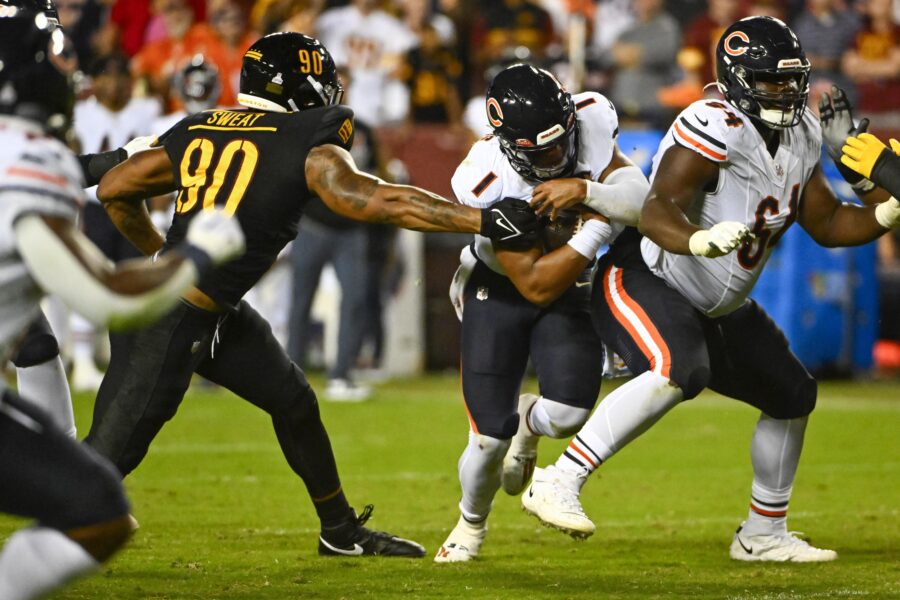 Oct 5, 2023; Landover, Maryland, USA; Chicago Bears quarterback Justin Fields (1) carries the ball past Washington Commanders defensive end Montez Sweat (90) during the first half at FedExField. Mandatory Credit: Brad Mills-USA TODAY Sports (Green Bay Packers)