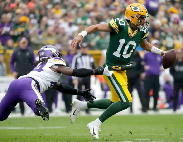 Green Bay Packers quarterback Jordan Love (10) is chased by Minnesota Vikings safety Josh Metellus (44) during their football game Sunday, October 29, 2023, at Lambeau Field in Green Bay, Wis. Minnesota defeated Green Bay 24-10. Wm. Glasheen USA TODAY NETWORK-Wisconsin