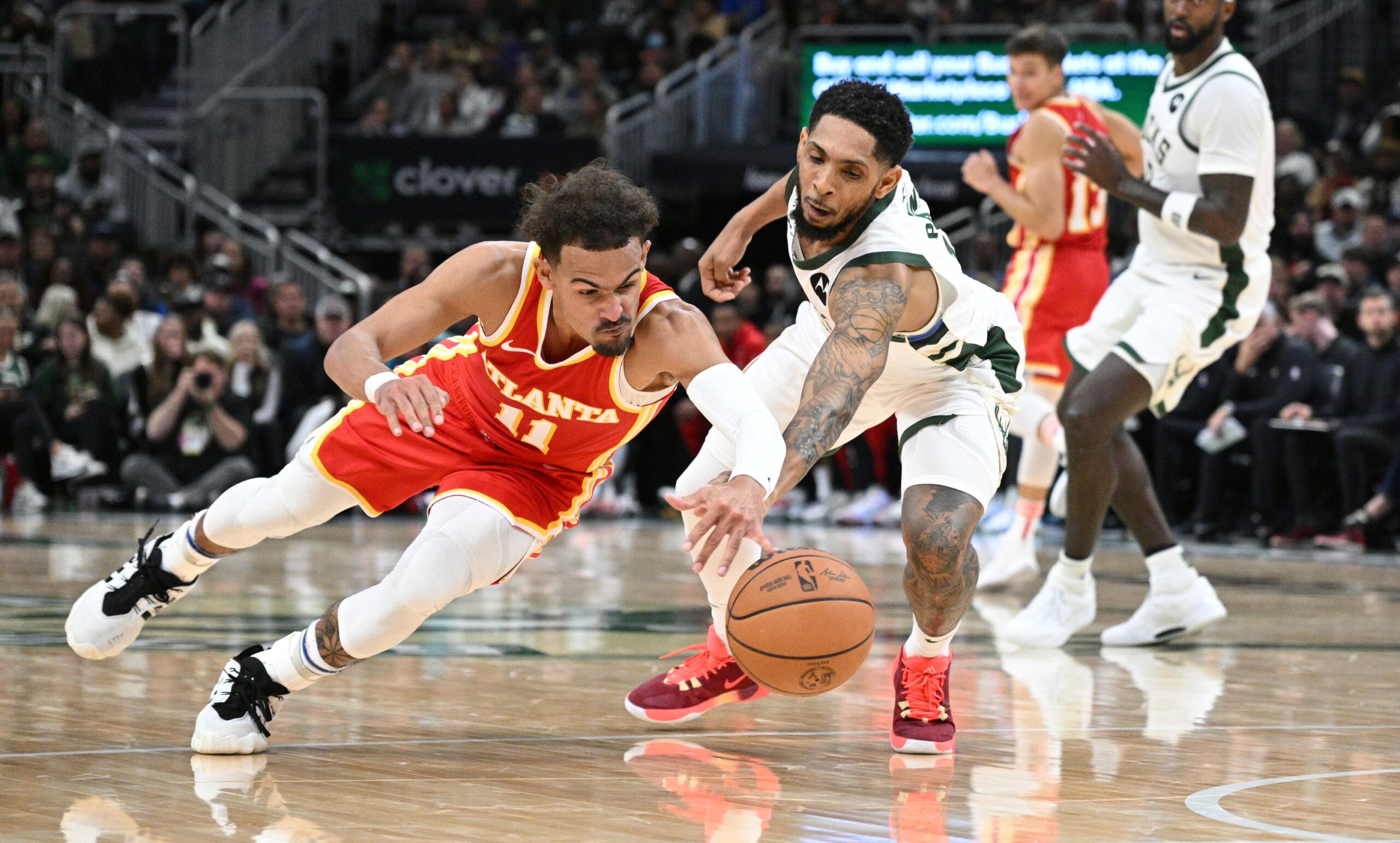 Oct 29, 2023; Milwaukee, Wisconsin, USA; Atlanta Hawks guard Trae Young (11) and Milwaukee Bucks guard Cameron Payne (15) battle for possession of the ball in the second half at Fiserv Forum. Mandatory Credit: Michael McLoone-USA TODAY Sports