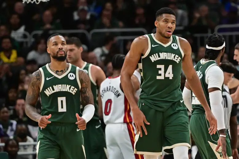 Oct 30, 2023; Milwaukee, Wisconsin, USA; Milwaukee Bucks forward Giannis Antetokounmpo (34) and guard Damian Lillard (0) looks on during a timeout in the fourth quarter against the Miami Heat at Fiserv Forum. Mandatory Credit: Benny Sieu-USA TODAY Sports