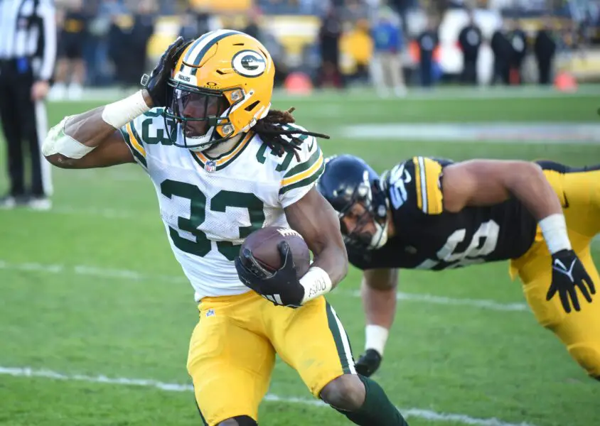Nov 12, 2023; Pittsburgh, Pennsylvania, USA; Green Bay Packers running back Aaron Jones (33) is chased out of bounds by Pittsburgh Steelers linebacker Alex Highsmith (56) during the fourth quarter at Acrisure Stadium. Mandatory Credit: Philip G. Pavely-USA TODAY Sports