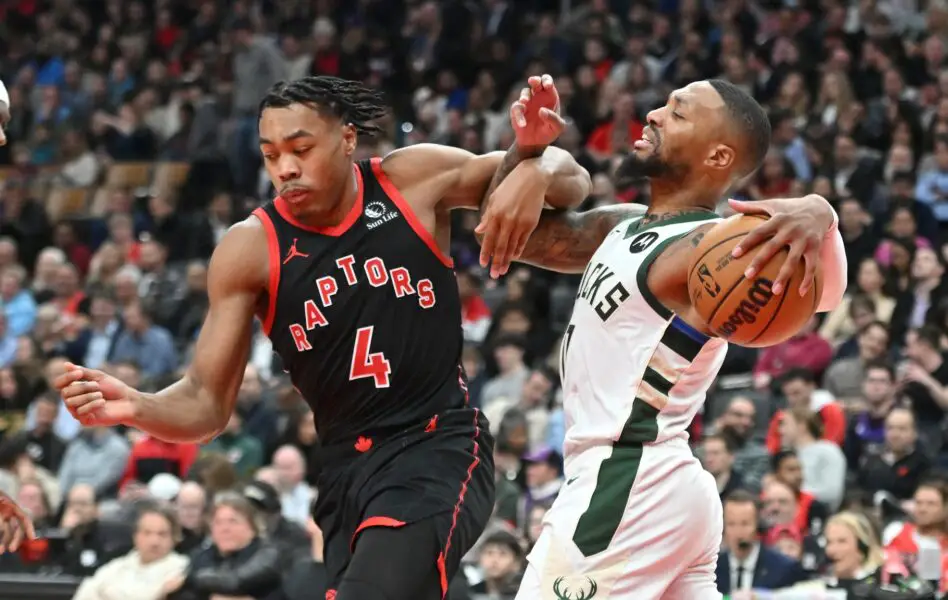 Nov 15, 2023; Toronto, Ontario, CAN; Milwaukee Bucks guard Damian Lillard (0) tangles arms with Toronto Raptors forward Scottie Barnes (4) in the first half at Scotiabank Arena. Mandatory Credit: Dan Hamilton-USA TODAY Sports