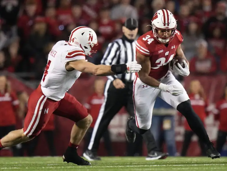 Wisconsin Badgers running back Jackson Acker (34) runs for six yards during the first quarter of their game against Nebraska Saturday, November 18, 2023 at Camp Randall Stadium in Madison, Wisconsin. © Mark Hoffman/Milwaukee Journal Sentinel / USA TODAY NETWORK