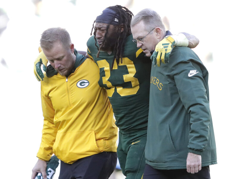 Nov 19, 2023; Green Bay, Wisconsin, USA; Green Bay Packers running back Aaron Jones (33) is helped off the field after getting injured in the second quarter against the Los Angeles Chargers at Lambeau Field. Mandatory Credit: Dan Powers-USA TODAY Sports