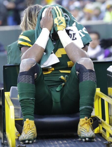 Nov 19, 2023; Green Bay, Wisconsin, USA; Green Bay Packers running back Aaron Jones (33) is carted off the field after getting injured in the second quarter against the Los Angeles Chargers at Lambeau Field. Mandatory Credit: Dan Powers-USA TODAY Sports