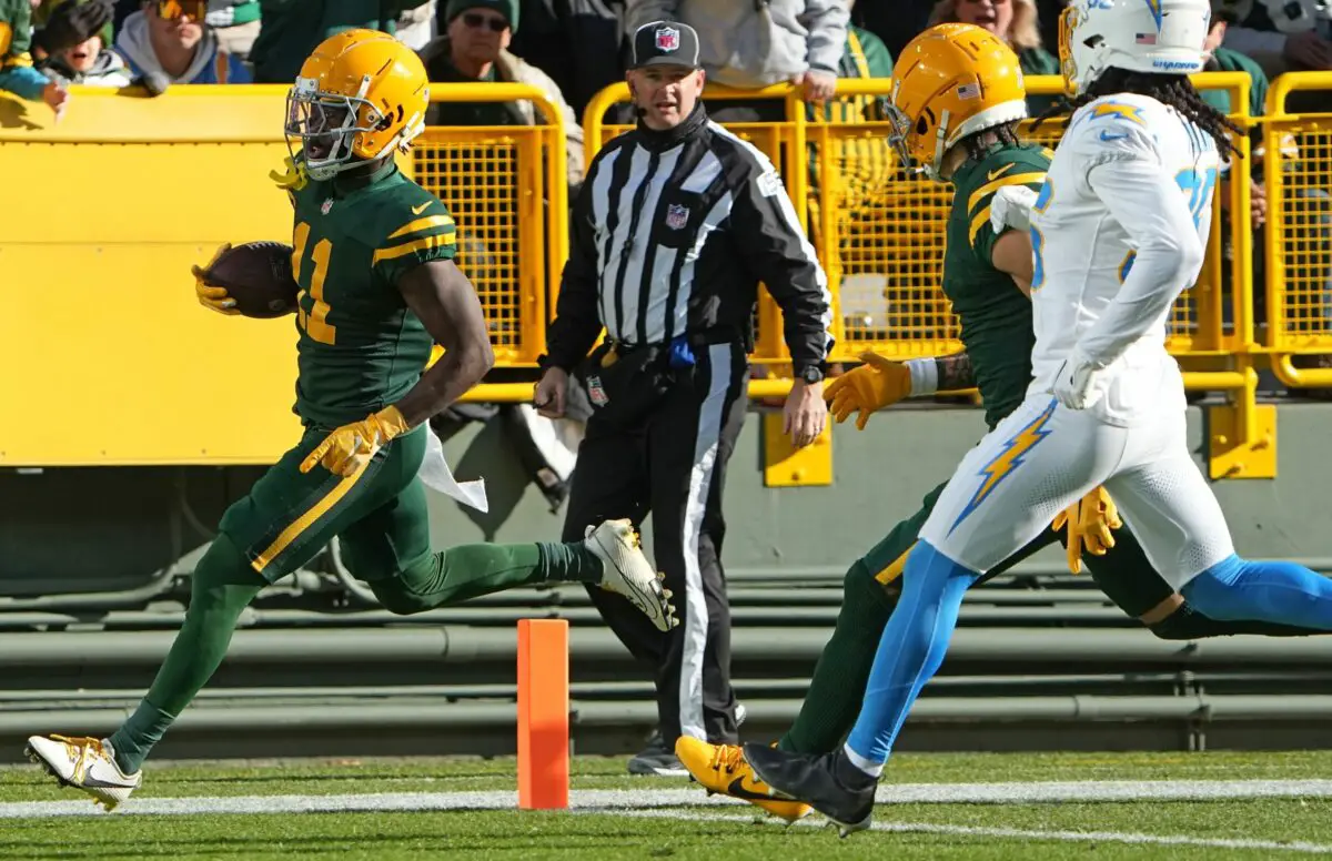 Nov 19, 2023; Green Bay, Wisconsin, USA; Green Bay Packers wide receiver Jayden Reed (11) scores a touchdown on a 32-yard run during the second quarter of their game against the Los Angeles Chargers at Lambeau Field. Mandatory Credit: Mark Hoffman-USA TODAY Sports