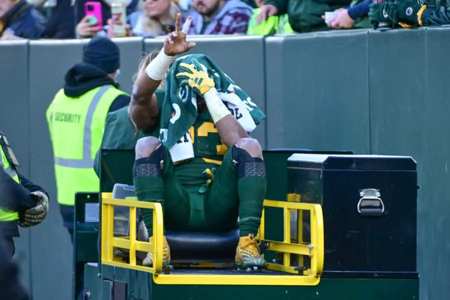 Nov 19, 2023; Green Bay, Wisconsin, USA; Green Bay Packers running back Aaron Jones (33) is carted off the field after he was injured in the second quarter against the Los Angeles Chargers at Lambeau Field. Mandatory Credit: Benny Sieu-USA TODAY Sports