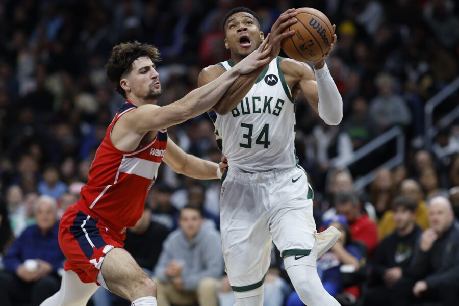 Nov 20, 2023; Washington, District of Columbia, USA; Milwaukee Bucks forward Giannis Antetokounmpo (34) is fouled while driving to the basket by Washington Wizards forward Deni Avdija (8) in the third quarter at Capital One Arena. Mandatory Credit: Geoff Burke-USA TODAY Sports