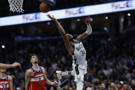 Nov 20, 2023; Washington, District of Columbia, USA; Milwaukee Bucks forward Giannis Antetokounmpo (34) shoots the ball after being fouled by Washington Wizards forward Deni Avdija (8) in the third quarter at Capital One Arena. Mandatory Credit: Geoff Burke-USA TODAY Sports