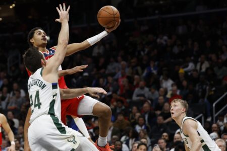 Nov 20, 2023; Washington, District of Columbia, USA; Washington Wizards guard Jordan Poole (13) shoots the ball as Milwaukee Bucks guard Pat Connaughton (24) defends in the second quarter at Capital One Arena. Mandatory Credit: Geoff Burke-USA TODAY Sports