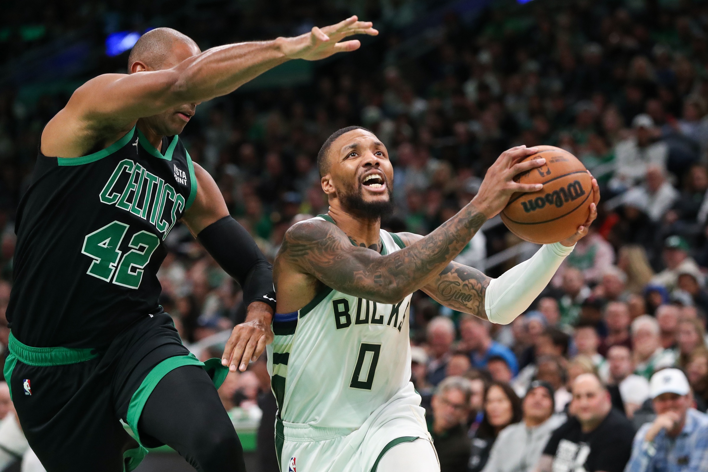 Nov 22, 2023; Boston, Massachusetts, USA; Milwaukee Bucks guard Damian Lillard (0) drives to the basket defended by Boston Celtics center Al Horford (42) during the second half at TD Garden. Mandatory Credit: Paul Rutherford-USA TODAY Sports
