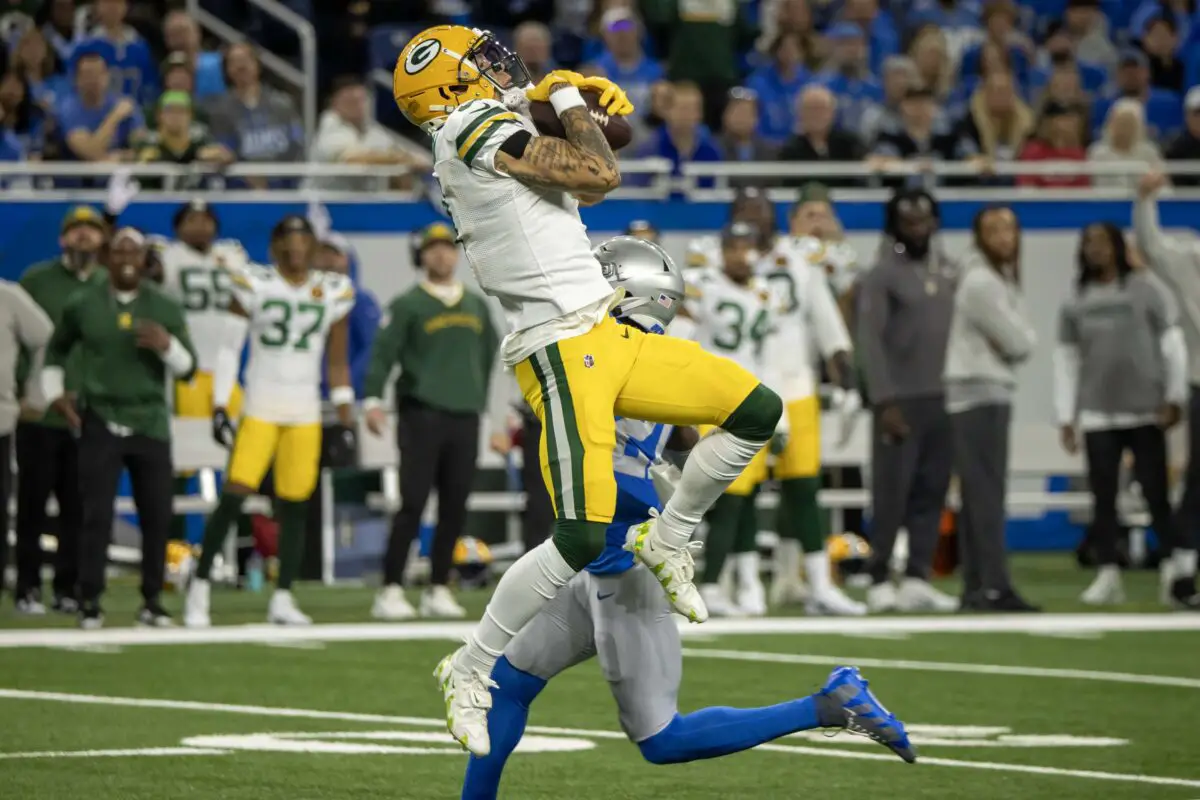Nov 23, 2023; Detroit, Michigan, USA; Green Bay Packers wide receiver Christian Watson (9) leaps in the air to catch a deep pass against the Detroit Lions in the first quarter during the annual Thanksgiving Day game at Ford Field. Mandatory Credit: David Reginek-USA TODAY Sports