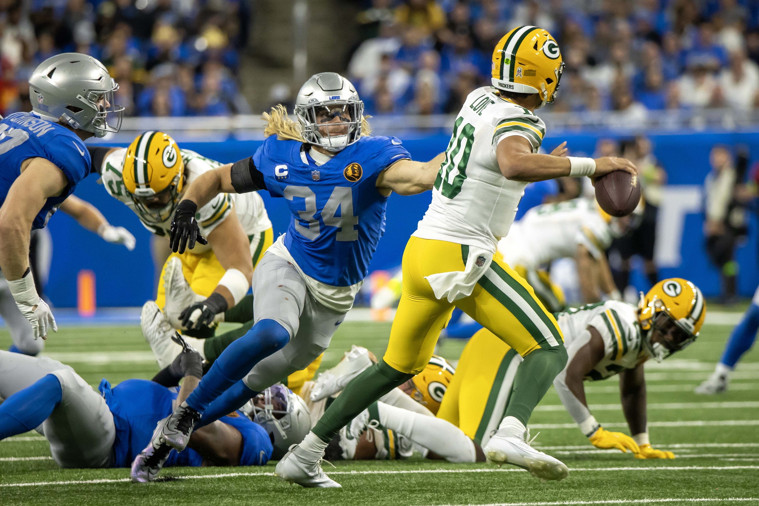 Nov 23, 2023; Detroit, Michigan, USA; Detroit Lions linebacker Alex Anzalone (34) pressures Green Bay Packers quarterback Jordan Love (10) in the second half during the annual Thanksgiving Day game at Ford Field. Mandatory Credit: David Reginek-USA TODAY Sports