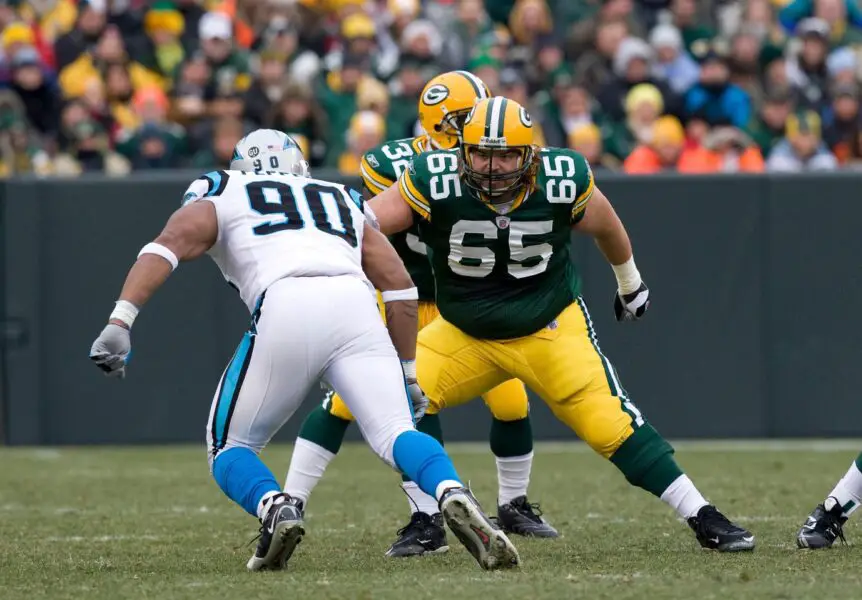 Nov 30, 2008; Green Bay, WI, USA; Carolina Panthers offensive guard Mackenzy Bernadeau (65) blocks Carolina Panthers defensive end Julius Peppers (90) during the game at Lambeau Field. The Panthers defeated the Packers 35-31. Mandatory Credit: Jeff Hanisch-USA TODAY Sports