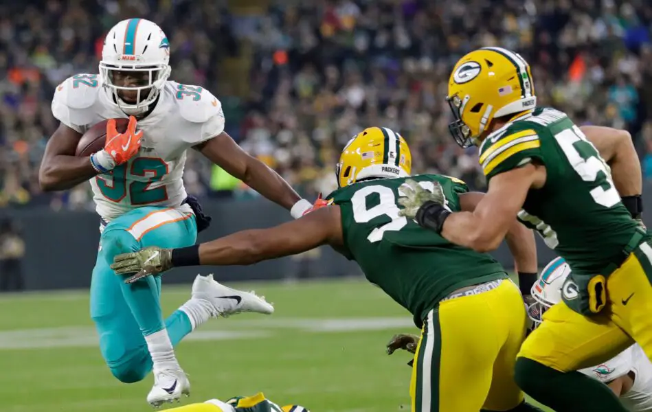 Miami Dolphins running back Kenyan Drake (32) dives for yardage against Green Bay Packers linebacker Reggie Gilbert (93) in the first half Sunday, November 11, 2018, Lambeau Field in Green Bay, Wis. Dan Powers/USA TODAY NETWORK-Wisconsin