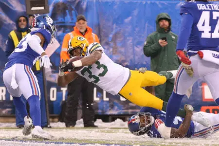 Dec 1, 2019; East Rutherford, NJ, USA; Green Bay Packers running back Aaron Jones (33) dives for yardage against New York Giants cornerback Sam Beal (23) and safety Antoine Bethea (41) during the third quarter at MetLife Stadium. Mandatory Credit: Brad Penner-USA TODAY Sports