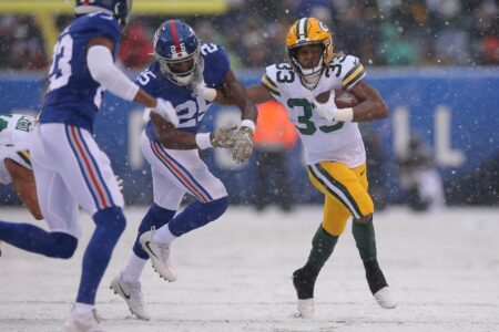 Dec 1, 2019; East Rutherford, NJ, USA; Green Bay Packers running back Aaron Jones (33) runs the ball against New York Giants cornerback Corey Ballentine (25) during the first quarter at MetLife Stadium. Mandatory Credit: Brad Penner-USA TODAY Sports