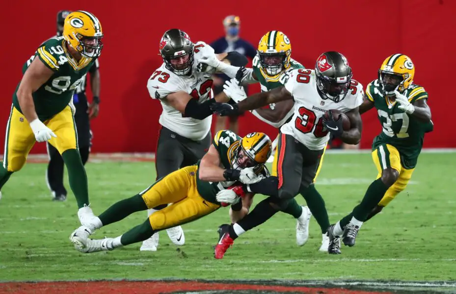 Oct 18, 2020; Tampa, Florida, USA; Tampa Bay Buccaneers running back Ke'Shawn Vaughn (30) runs against Green Bay Packers linebacker Ty Summers (44) during the fourth quarter of a NFL game at Raymond James Stadium. Mandatory Credit: Kim Klement-USA TODAY Sports